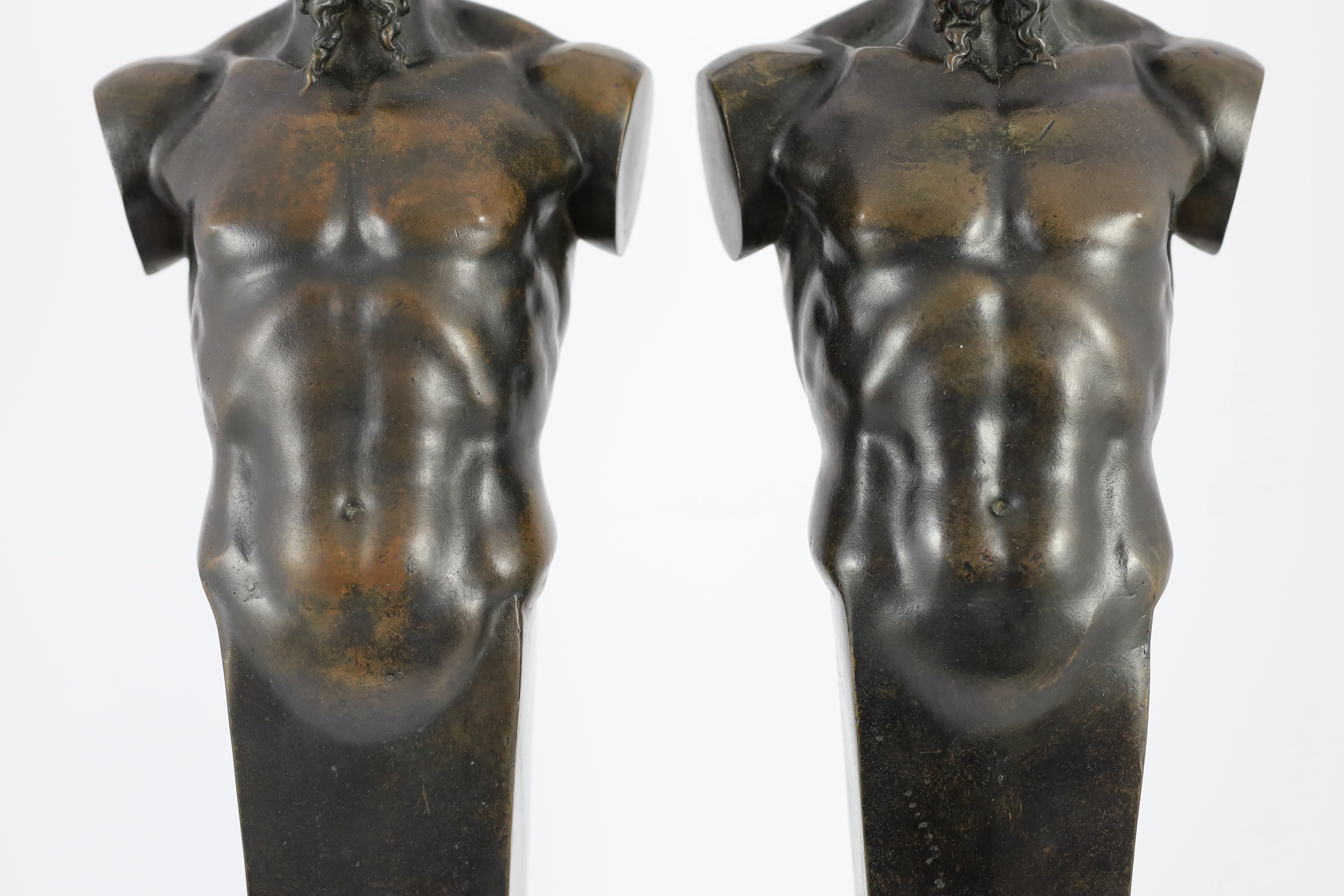 A pair of early 20th century French bronze terms, each in the form of a satyr, 16cm wide 62cm high